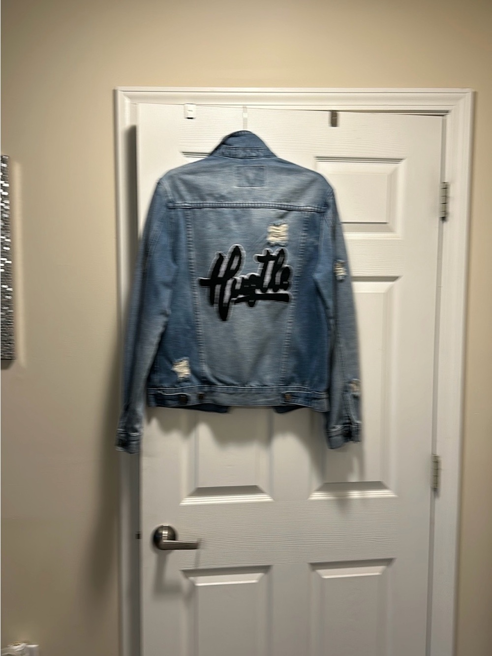 Light Wash Distressed Denim Jacket with Black Script Patch